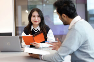 Postgraduate students working together on campus.