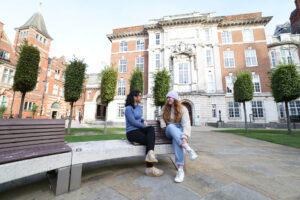 Postgraduate students sitting and talking in the Quad.