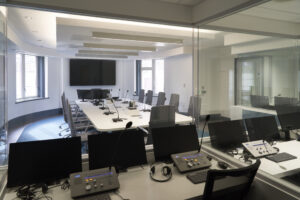An Interpreting Suite room with interpreting equipment such as microphones, computers and recording equipment.