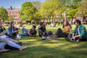 An image of students sat in Abercromby Square (a small greenspace in the middle of campus).