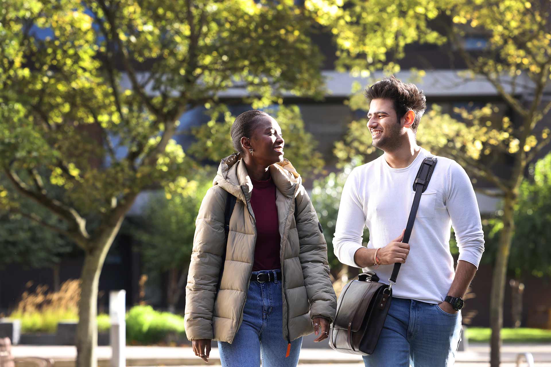 Postgraduate students walking through the campus.