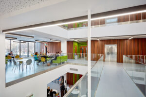 Image of a corridor, lifts and seating area on the first floor of the Management School.