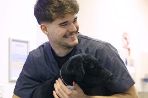 A Veterinary student with a dog
