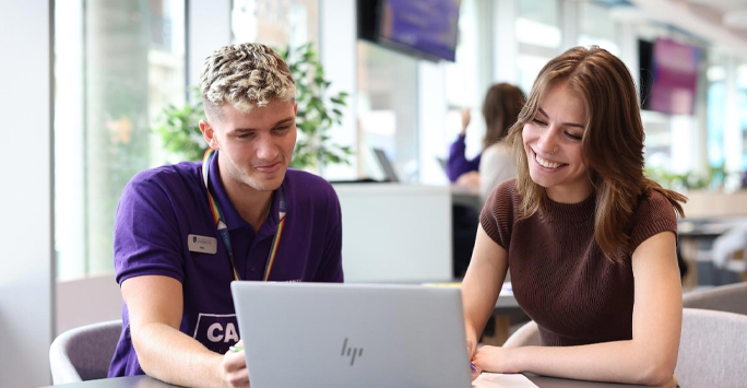 Careers Coach and student looking at information on a laptop