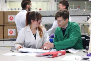 Two chemistry students working together in a laboratory