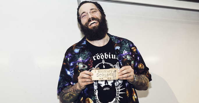 Dr Matt Taylor smiling and holding a prop that says honorary scouser.