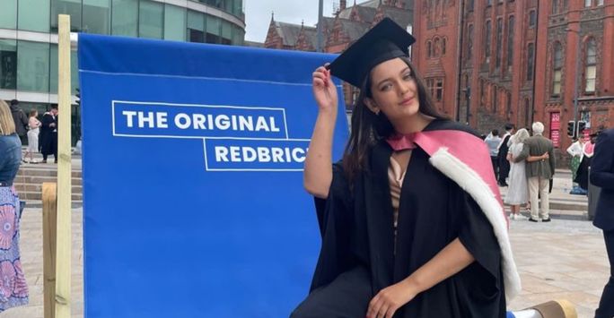 Mia Hargreaves sits on a giant deck chair in University Square after graduating.