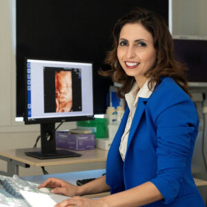 Professor Asma Khalil working at a computer